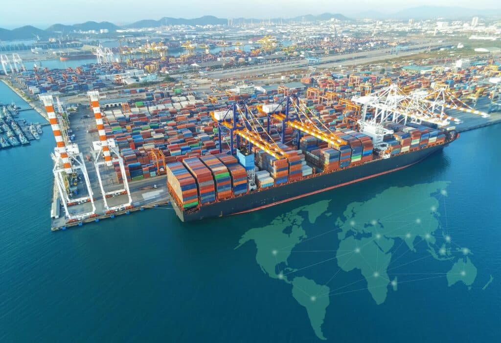 Aerial view of a commercial cargo ship in port with many shipping containers, representing Canadian customs and import regulations