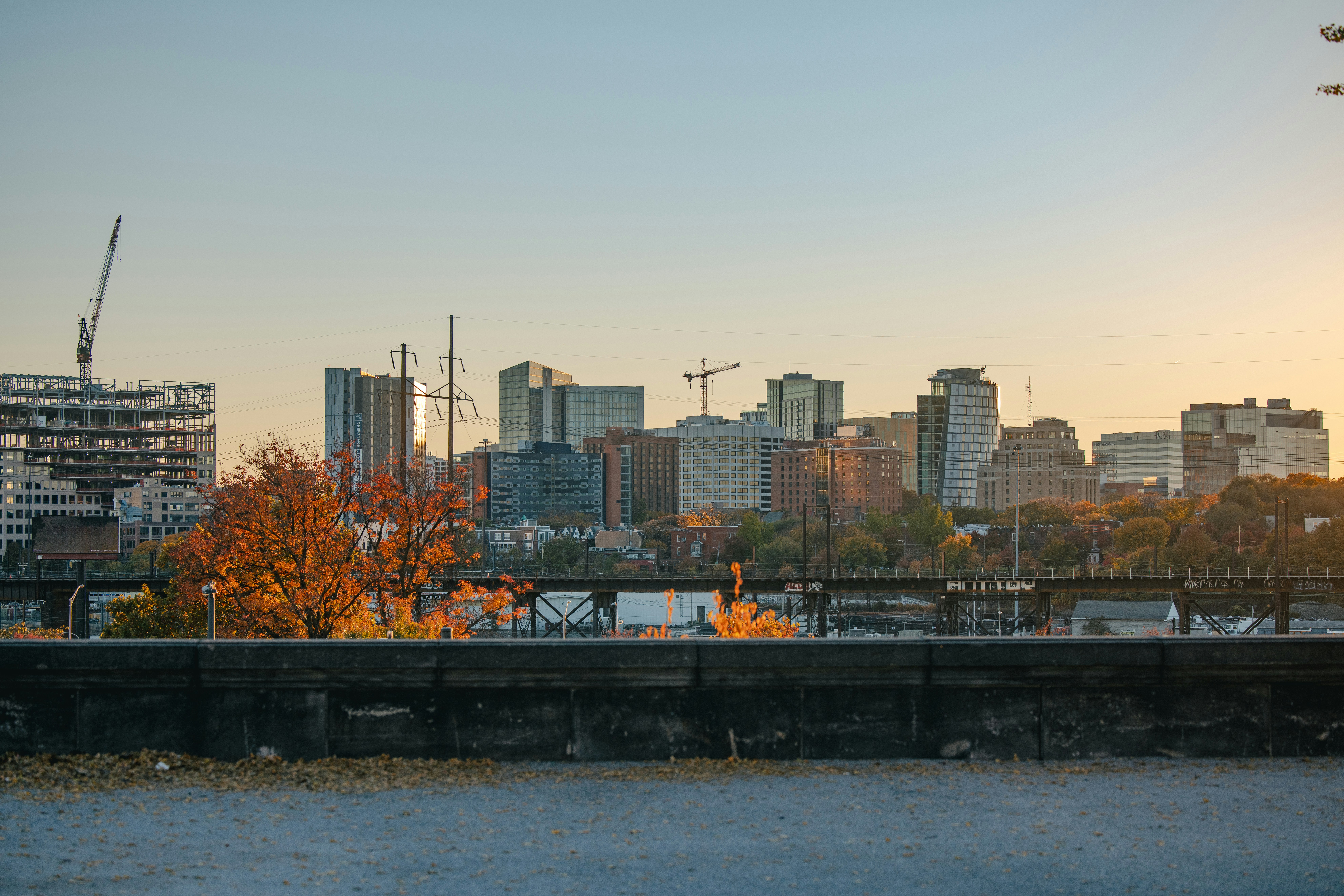 A view of a city with a bridge and a variety of commercial and residential buildings in the background. The photo is a great representation of the city's urban environment and is relevant to topics such as corporate governance for Windsor-Essex businesses.