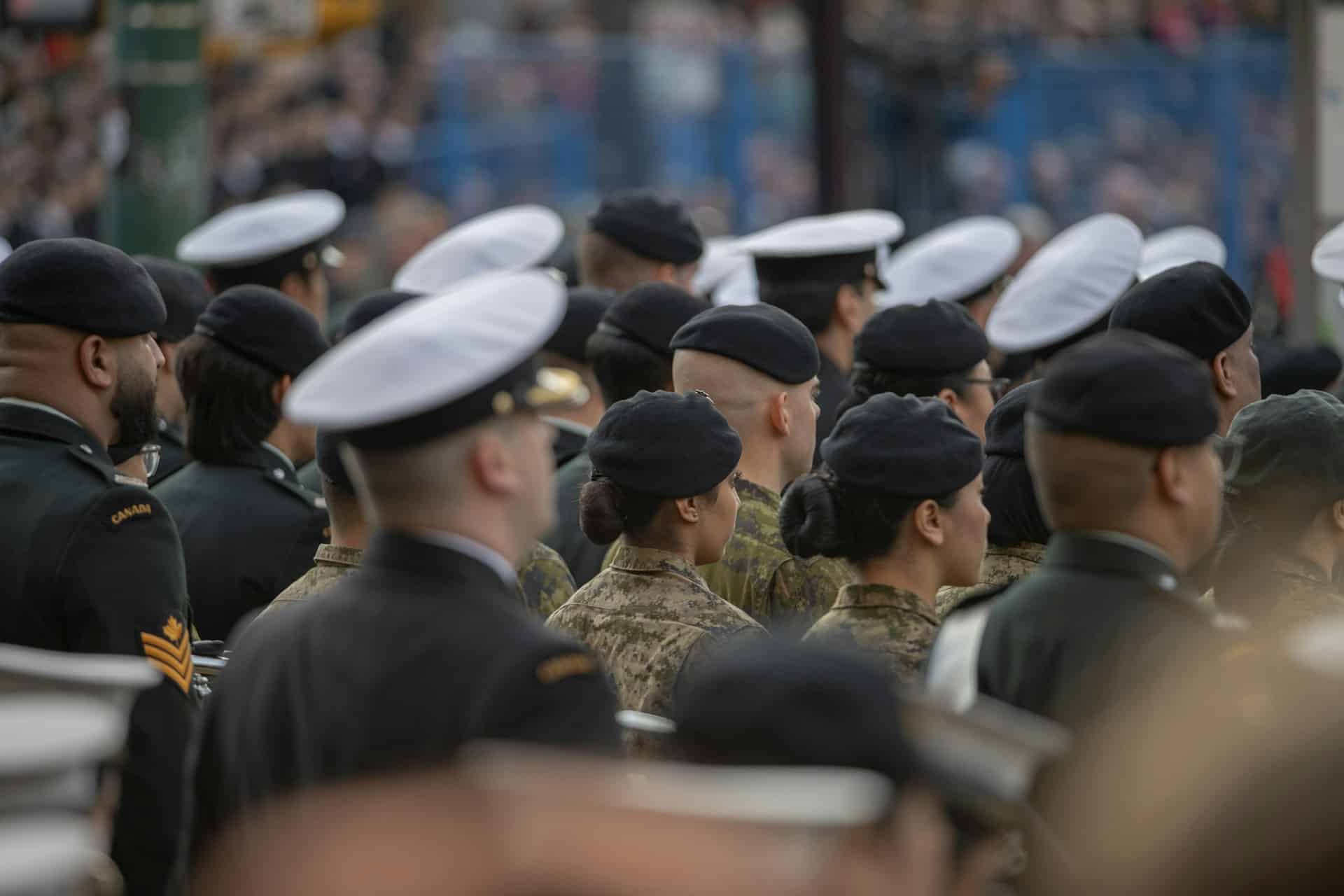 Canadian Military soliders standing at a memorial.