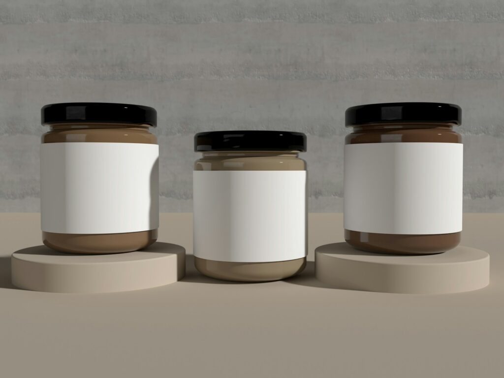 A row of three jars with blank labels, the two at both ends sitting on small round pedestals, representing selling regulated products in Canada.
